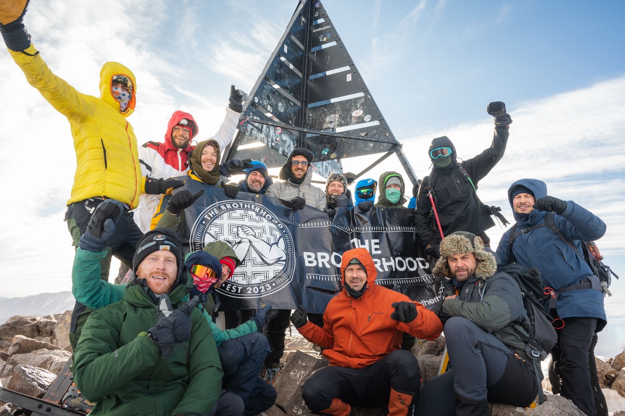 The Brotherhood team at the snowy summit of Mount Toubkal